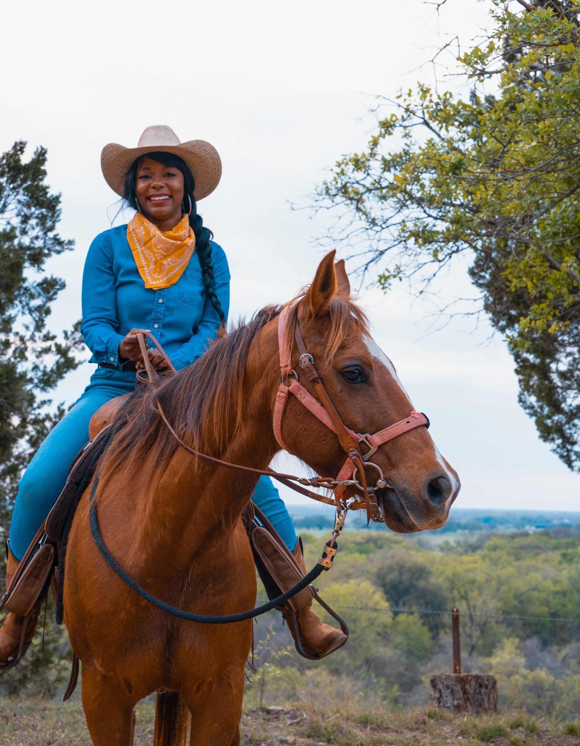 Colby Holiday on horseback wearing a cowboy hat and bandana, Waco Texas, portrait crop